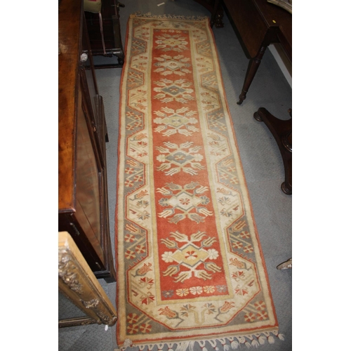 652 - A Kazak runner of traditional design, with seven star  medallions in shades of rust, tan, grey and n... 