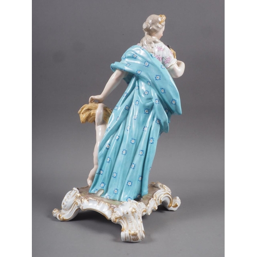 18 - A Meissen porcelain figure of Autumn, in gilt scroll work base, 11