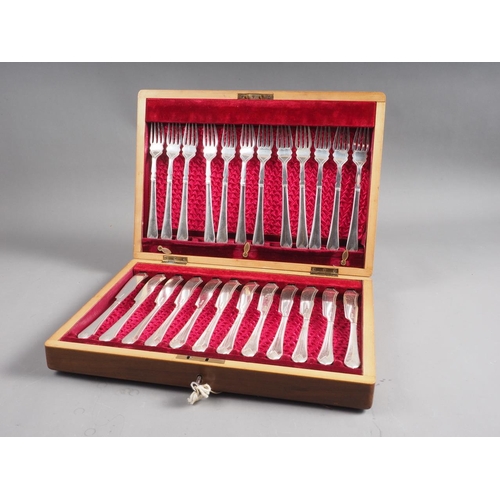 269 - A set of twelve silver plated fish knives and forks, in mahogany canteen