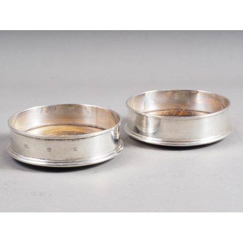 291 - A pair of silver bottle coasters with turned bases