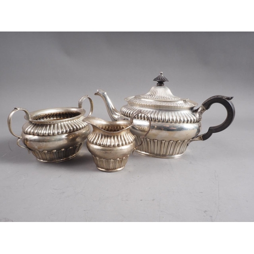 298 - A three-piece silver teaset with gadrooned decoration, 29.5oz troy approx