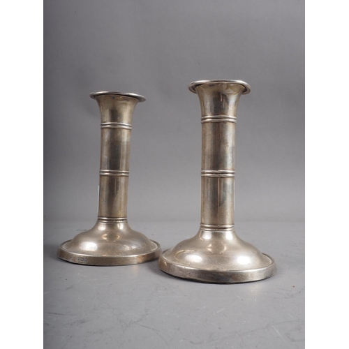 300 - A pair of silver candlesticks with banded decoration, 5