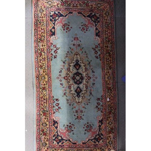 648 - A Persian rug of traditional design with central medallion on a turquoise blue ground and bordered i... 