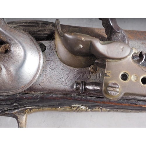 190 - A Continental flintlock long barrel pistol with carved and inlaid stock, 19