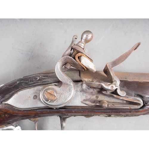 196 - A Continental flintlock pistol with carved and inlaid walnut stock, 19