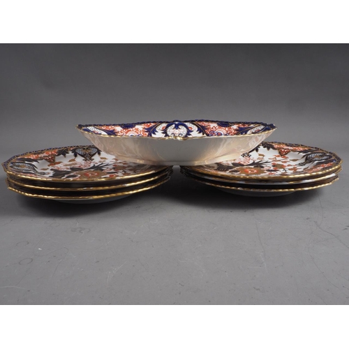 53 - Seven Royal Crown Derby plates with Imari decoration and a similar shaped dish, 11