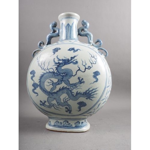 86 - A Chinese blue and white porcelain dragon handled and decorated moon flask, 16 3/4