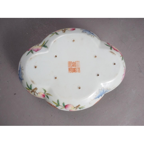 98 - A Chinese famille rose shaped dish with bat, peach and character decoration, and seal mark to base, ... 