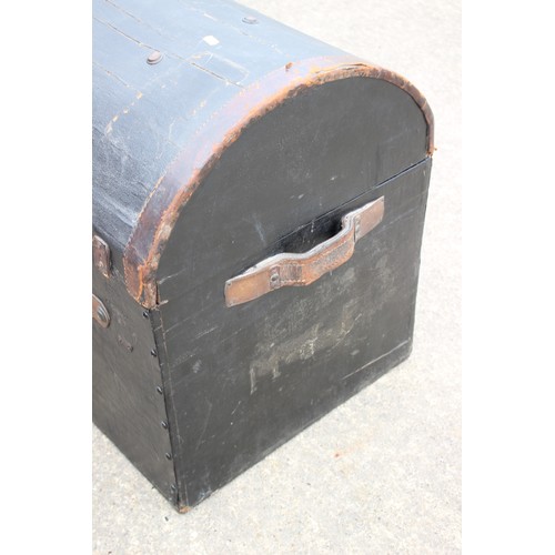 657 - A black leather bound dome topped trunk with leather carrying straps and floral patterned interior, ... 