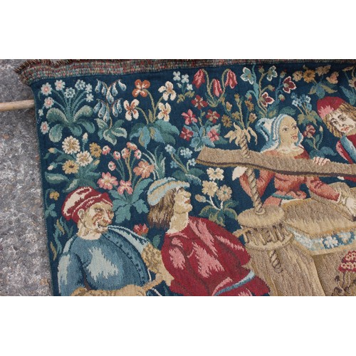 158 - A Jacquard woven tapestry with figures in a landscape design, 73 1/2