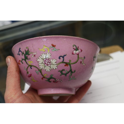 94 - A Chinese bowl with floral scrolled decoration on a pink enamelled ground and seal mark to base, 5 3... 