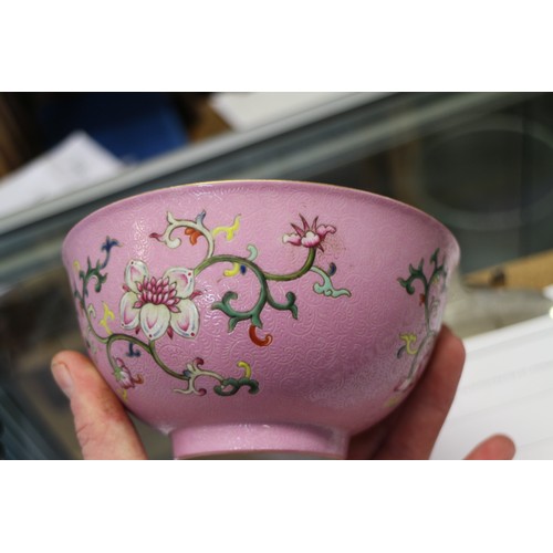 94 - A Chinese bowl with floral scrolled decoration on a pink enamelled ground and seal mark to base, 5 3... 