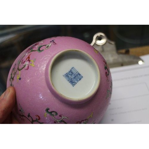 94 - A Chinese bowl with floral scrolled decoration on a pink enamelled ground and seal mark to base, 5 3... 