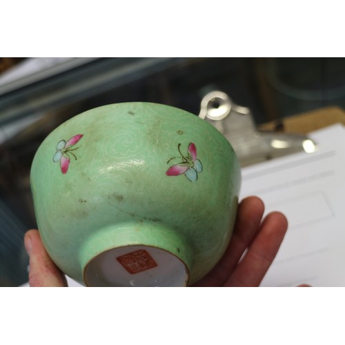 94 - A Chinese bowl with floral scrolled decoration on a pink enamelled ground and seal mark to base, 5 3... 