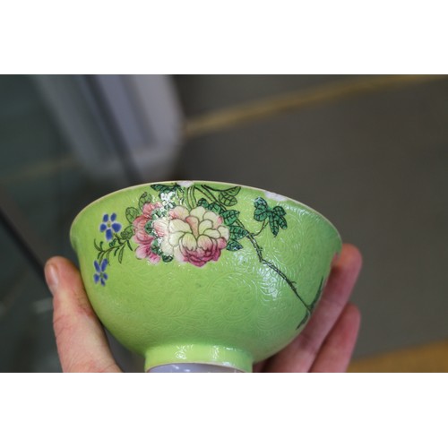 94 - A Chinese bowl with floral scrolled decoration on a pink enamelled ground and seal mark to base, 5 3... 