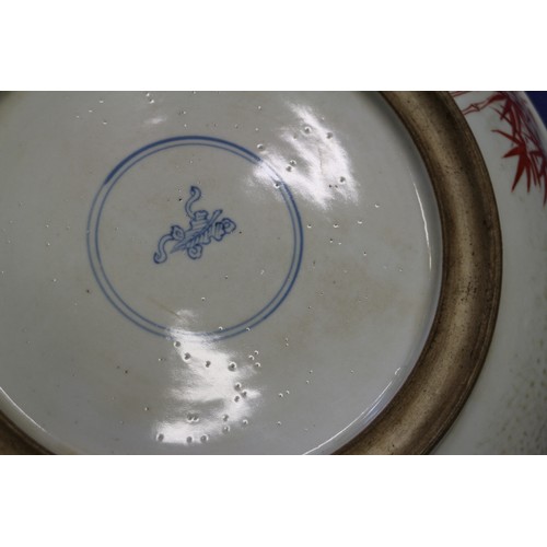 96 - A Chinese famille verte dish with warrior decoration, 12 3/4