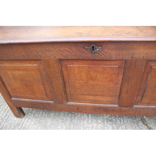 465 - An early 18th century oak triple panel front coffer with candle box, on stile supports, 52