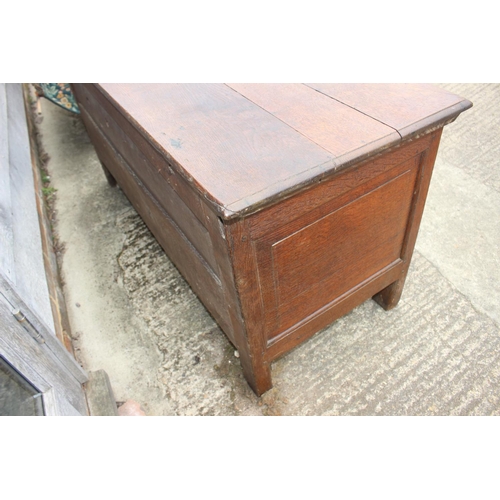 465 - An early 18th century oak triple panel front coffer with candle box, on stile supports, 52