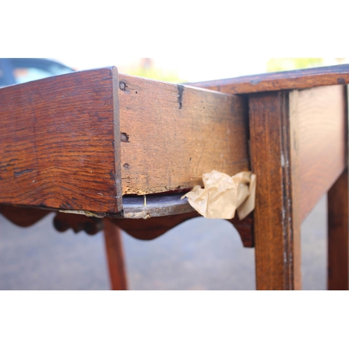 466 - An antique oak elm and walnut side table, fitted one drawer, on chamfered and stretchered supports, ... 