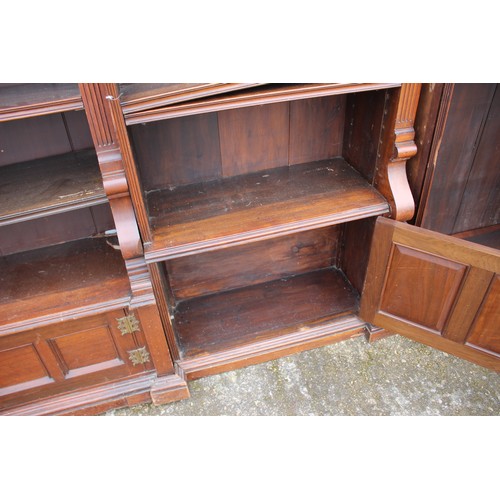 467 - A 19th century walnut open bookcase with fitted adjustable shelves and cupboards