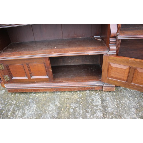 467 - A 19th century walnut open bookcase with fitted adjustable shelves and cupboards