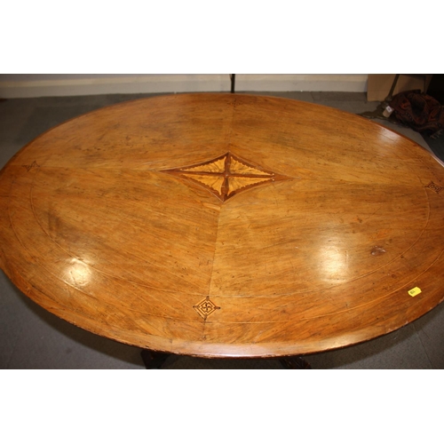 484 - A late Victorian walnut and scroll paterae inlaid oval loo table, on turned column and splay support... 