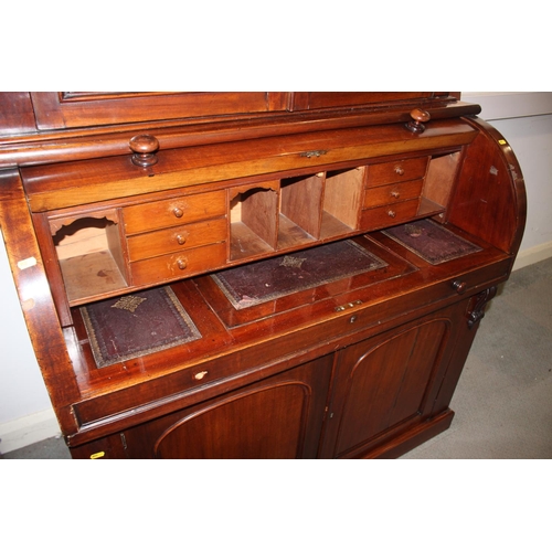 490 - A mid Victorian mahogany cylinder bureau bookcase, the upper section enclosed two glazed panel doors... 