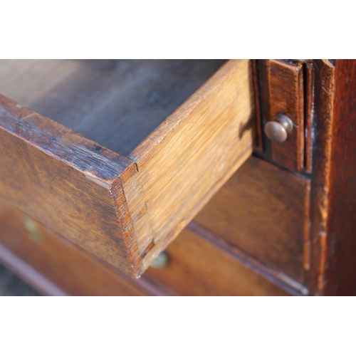 494 - A late Georgian oak fall front bureau with part fitted interior over four long graduated drawers, on... 