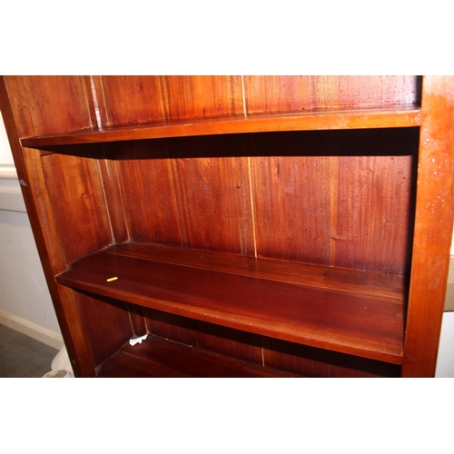 535 - A hardwood bookcase, fitted open shelves over two drawers, on bracket feet, 38