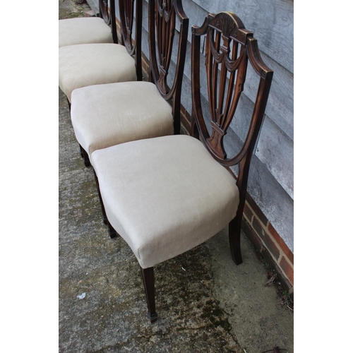 578 - A set of four carved mahogany Sheraton revival standard dining chairs with shield-shaped backs, on s... 