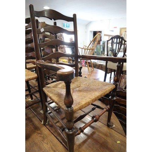 580 - A pair of ladder back carver chairs with rush envelope seats, on turned and stretchered supports, th... 