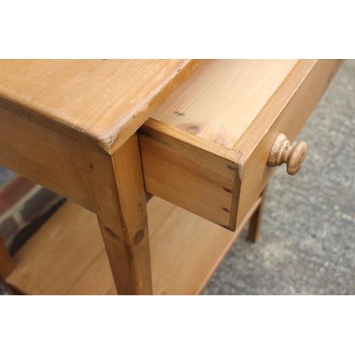 593 - A waxed pine two-tier side table, fitted one drawer, on square taper supports, 21