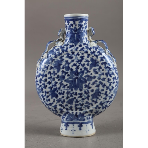 105 - A Chinese blue and white moon flask with relief lizard, leaf and scrolled decoration, 9 1/2