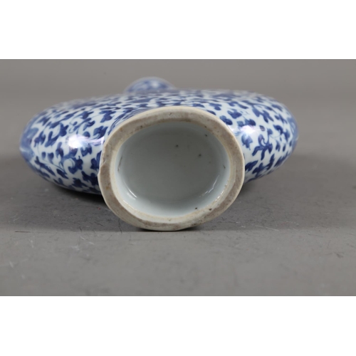 105 - A Chinese blue and white moon flask with relief lizard, leaf and scrolled decoration, 9 1/2