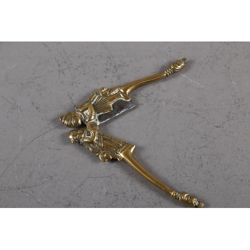 156 - An Indian brass and steel betel nut cutter with figure decoration, 5 1/2