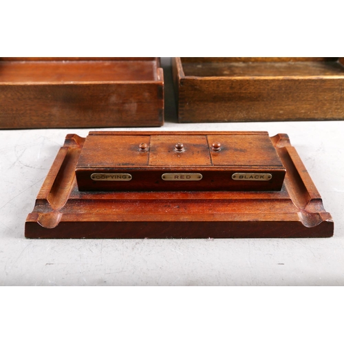 159 - Two wooden desk filing trays and a wooden inkstand, fitted three inkwells