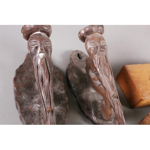 162 - A pair of Japanese carved hardwood wall sconces, formed as bearded figures, 14