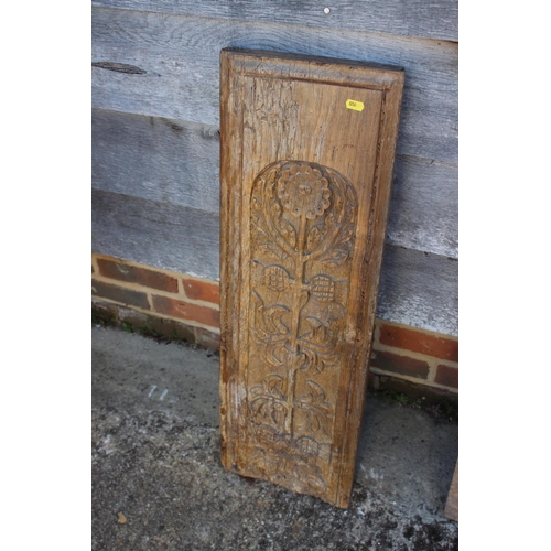 169 - A pair of 17th century carved oak panels with stylised flower designs, 32