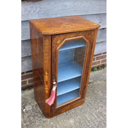 438 - A late 19th century figured walnut and inlaid music cabinet enclosed glazed door, on block base, 20