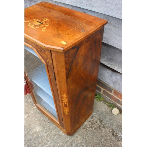 438 - A late 19th century figured walnut and inlaid music cabinet enclosed glazed door, on block base, 20