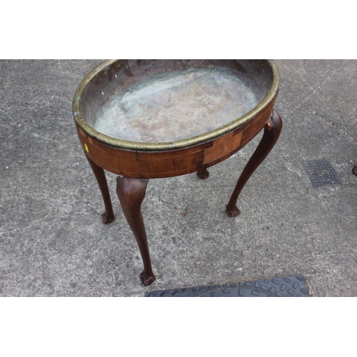 441 - A 19th century walnut and brass inset oval planter, on cabriole claw and ball supports, 22