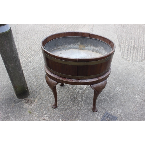 442 - A 19th century mahogany and brass bound oval planter with zinc lining, on turned supports and pad fe... 