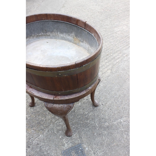 442 - A 19th century mahogany and brass bound oval planter with zinc lining, on turned supports and pad fe... 