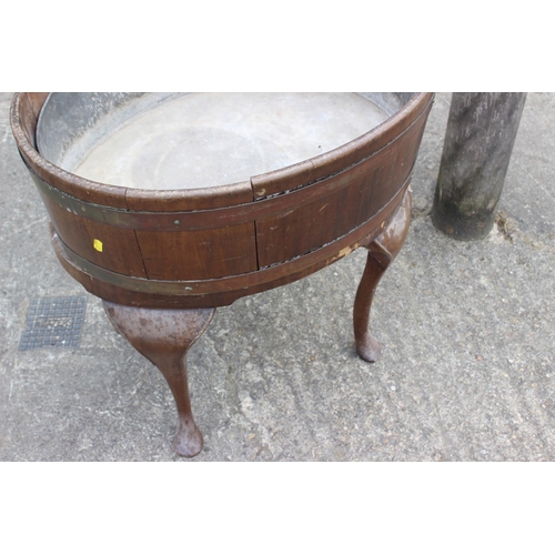 442 - A 19th century mahogany and brass bound oval planter with zinc lining, on turned supports and pad fe... 