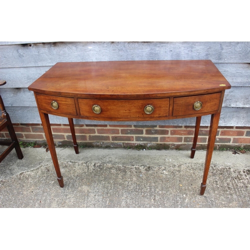 446 - A 19th century mahogany bowfront carving table, fitted three drawers with ring handles, on square ta... 