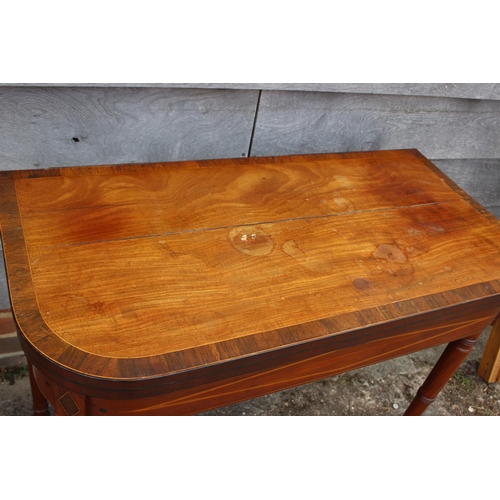 449 - An early 19th century mahogany rosewood banded and box line inlaid fold-over top card table, on turn... 