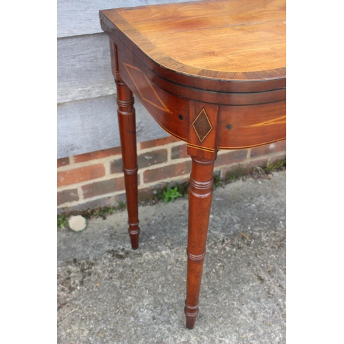 449 - An early 19th century mahogany rosewood banded and box line inlaid fold-over top card table, on turn... 