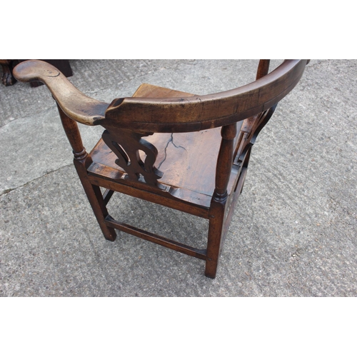 450 - A Georgian mahogany corner elbow chair with pierced splat back and panel seat