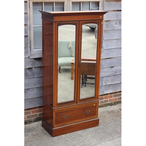 462 - An Edwardian mahogany and banded wardrobe, fitted two arch top mirrored doors with bevelled plates o... 