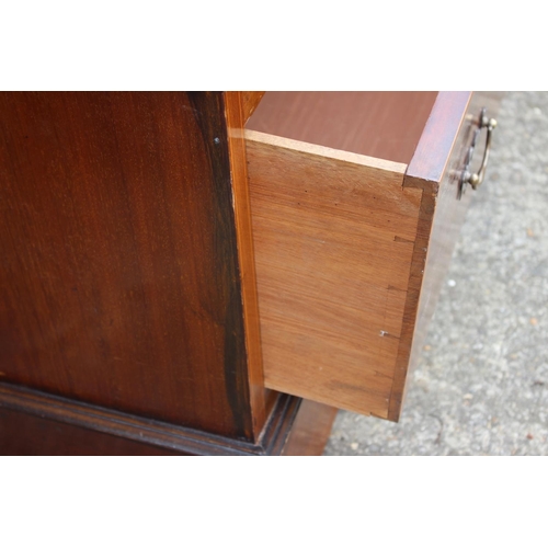 462 - An Edwardian mahogany and banded wardrobe, fitted two arch top mirrored doors with bevelled plates o... 